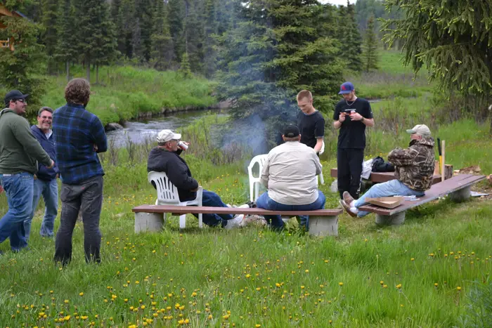 The crew gathered together around the picnic table