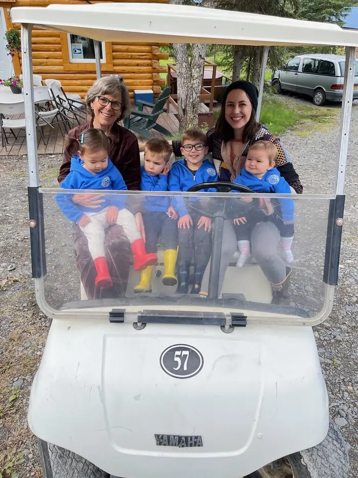 A family loaded onto the golf cart, all smiles