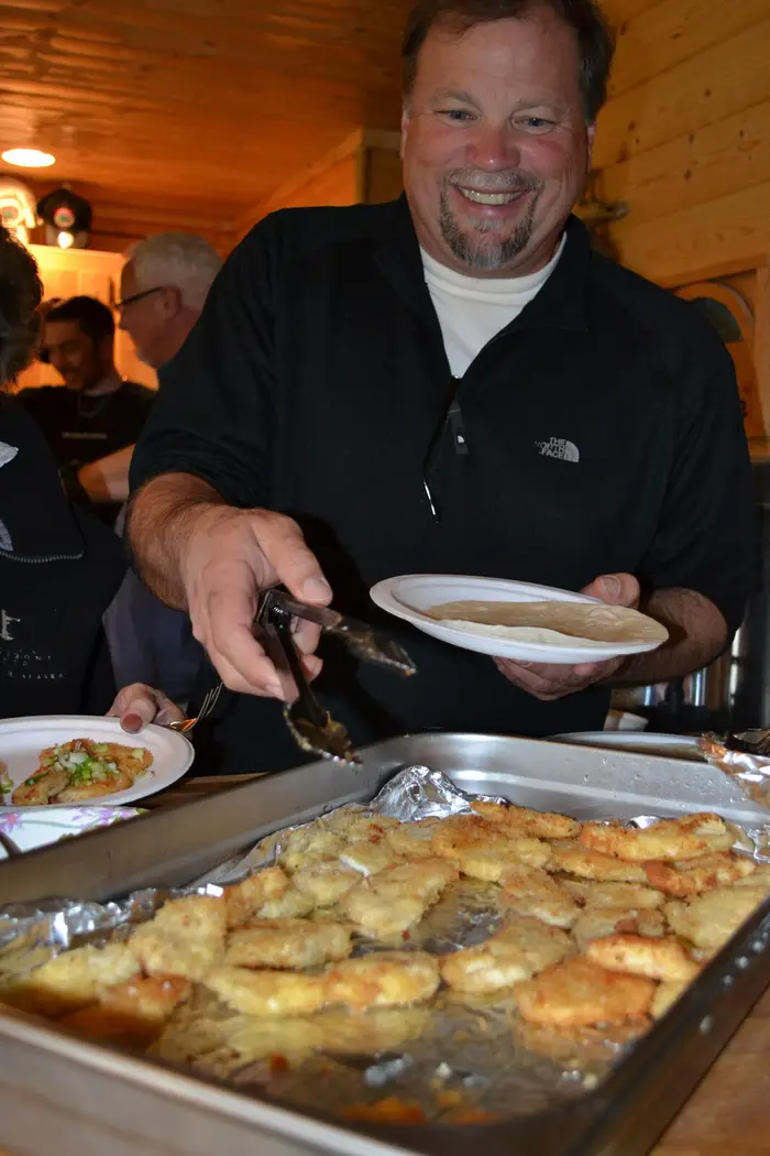Serving up a hot dinner from the tray line