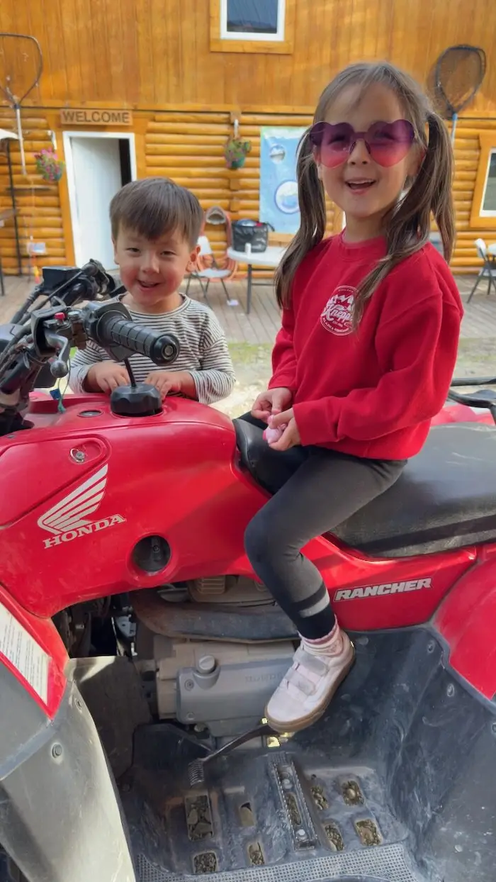 Kids on the ATV, grinning