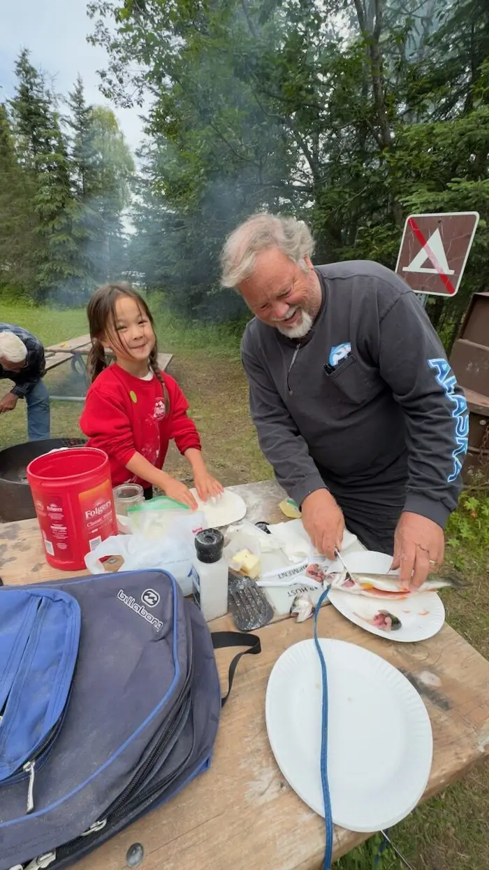Cleaning the day's catch at the camp table