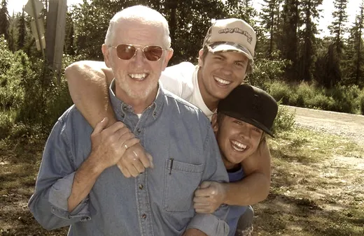 Family group portrait outdoors with hats and sunglasses