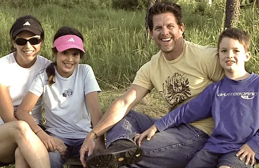 Two men smiling together in casual outdoor setting