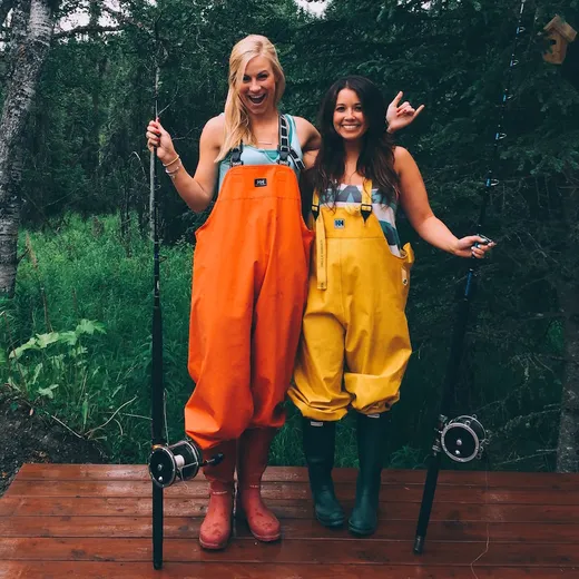 Couple posing together outside the lodge, smiling at camera.