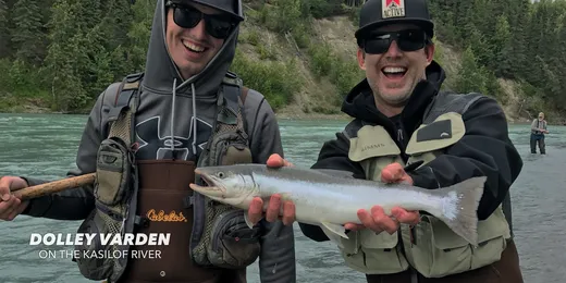 Angler holding up a big sockeye salmon on the water.