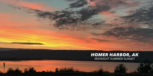 Vivid sunset over Homer Harbor, Alaska with orange and purple sky