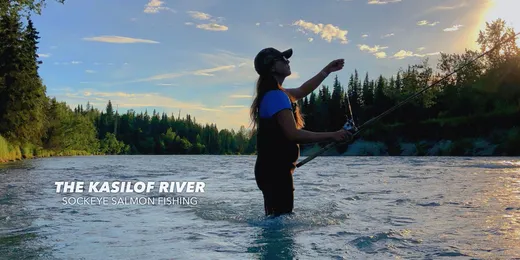 Angler wading and casting on a clear Alaska river
