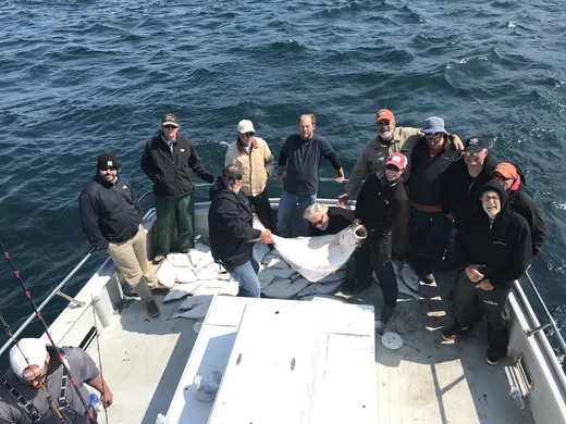 Group of guests on a boat headed out for a fishing trip