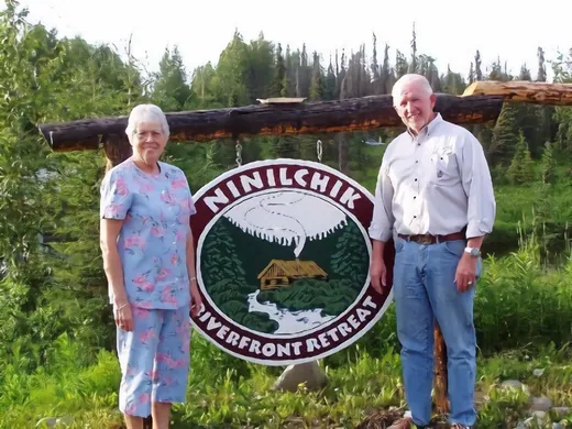 Group portrait of guests posed together outdoors at the camp.