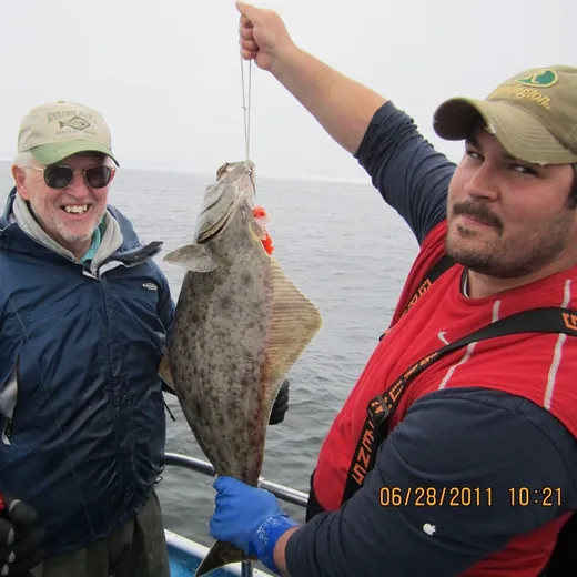 Guide and guest show off a silver salmon together.