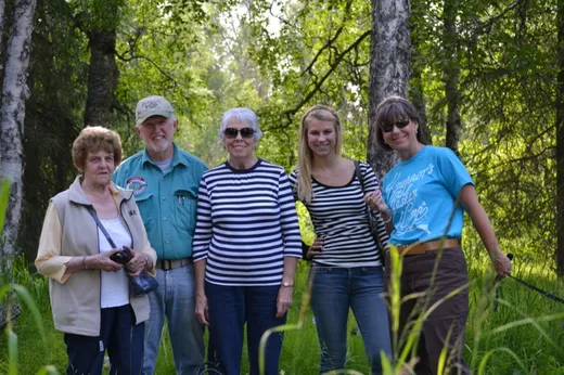 Group of guests posing together outdoors at camp.