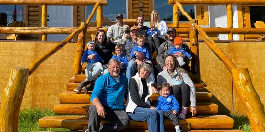 Full group of guests in matching blue rain jackets